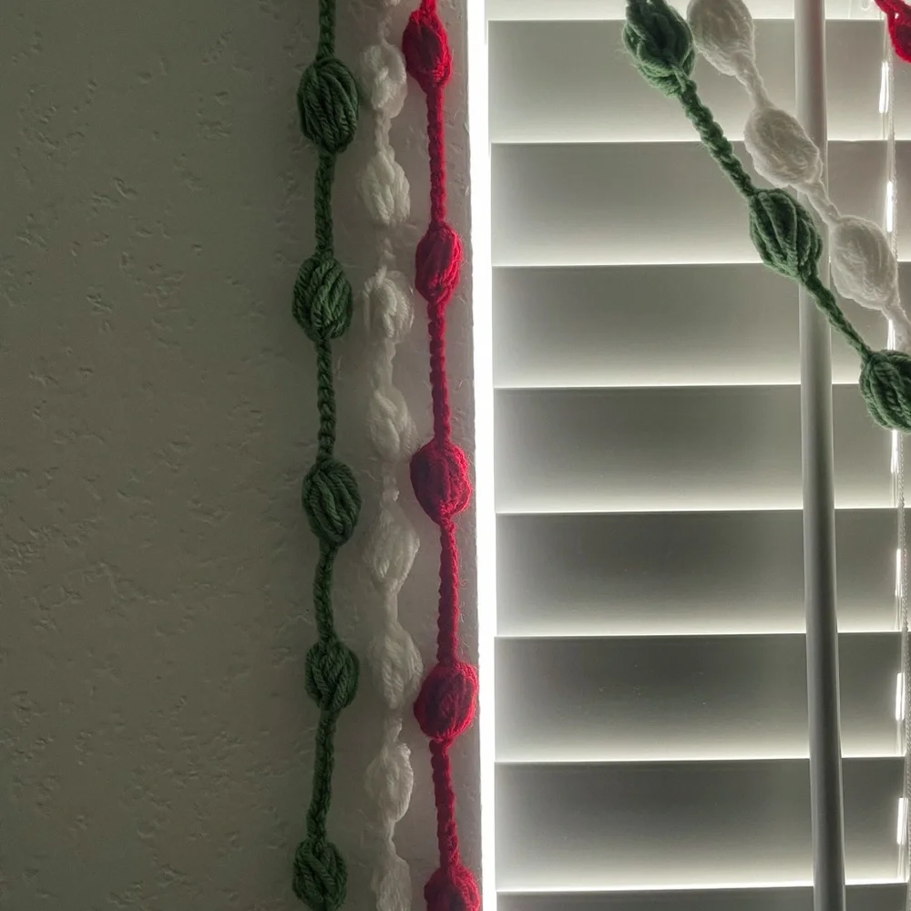 3 separate strands green, red and off white of homemade crocheted garland 9 ft